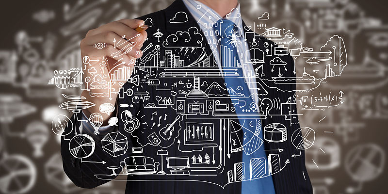 Businessman with marker writing business ideas on screen